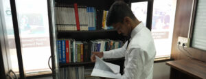 Stuent Pilot Reading a Book in the Library